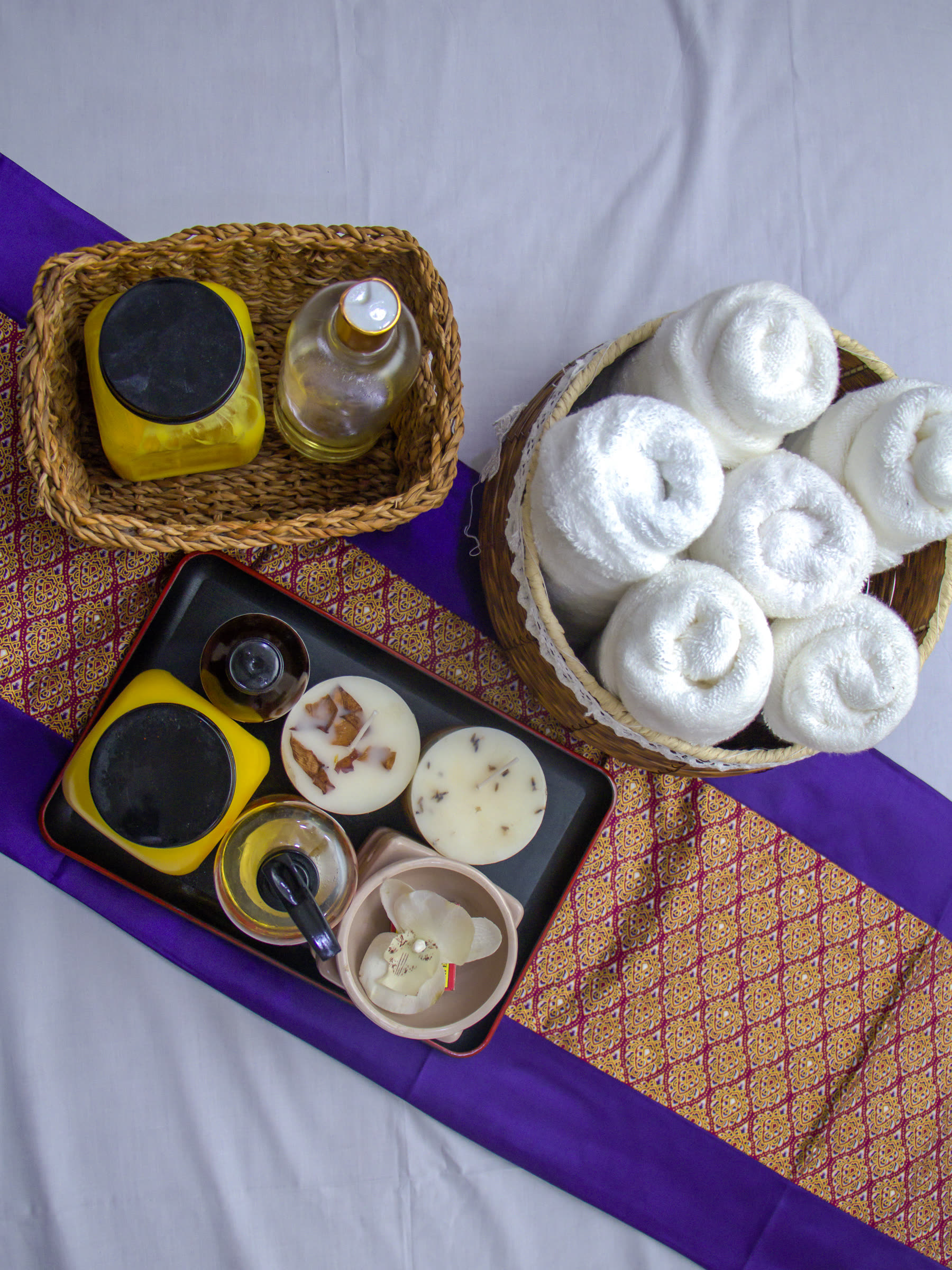 Massage oils, treatment candles and rolled towels prepared at Beckindales