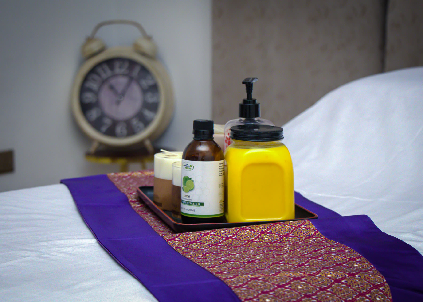 Essential oils and body treatment products arranged on a Beckindales massage bed