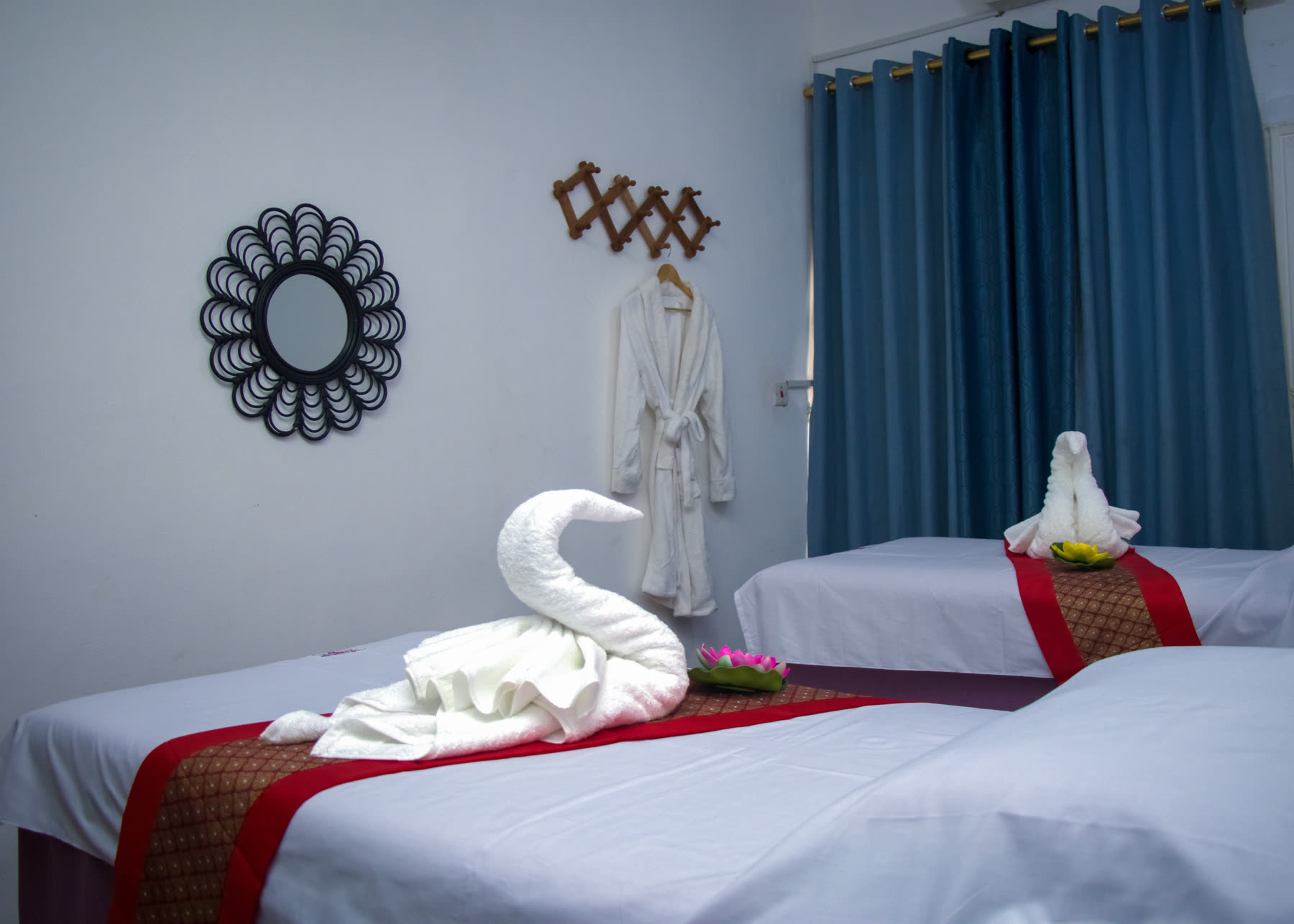 Beckindales massage room prepared with two treatment beds and folded-towel swans