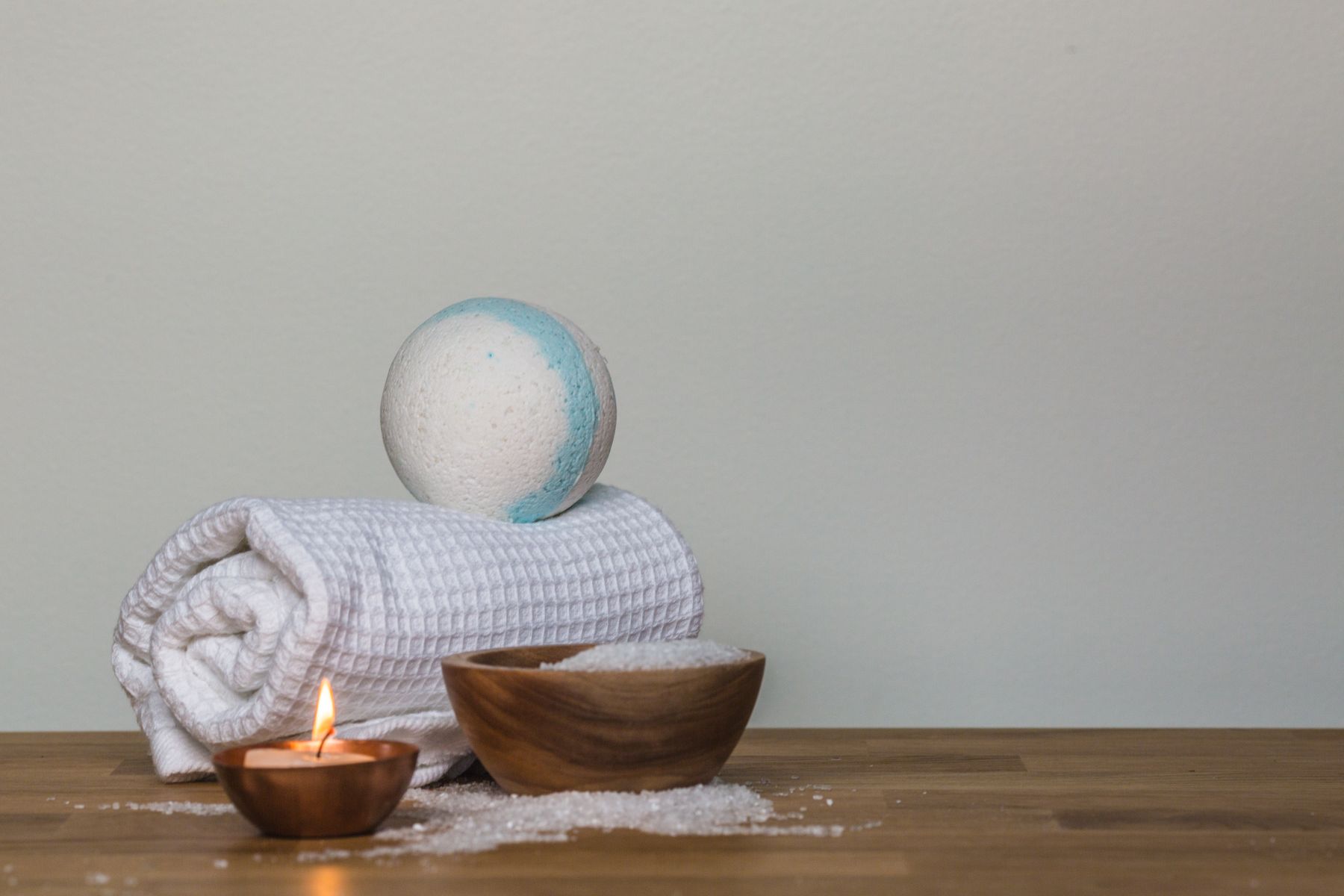 Candles, towels and spa essentials arranged for a relaxing celebration