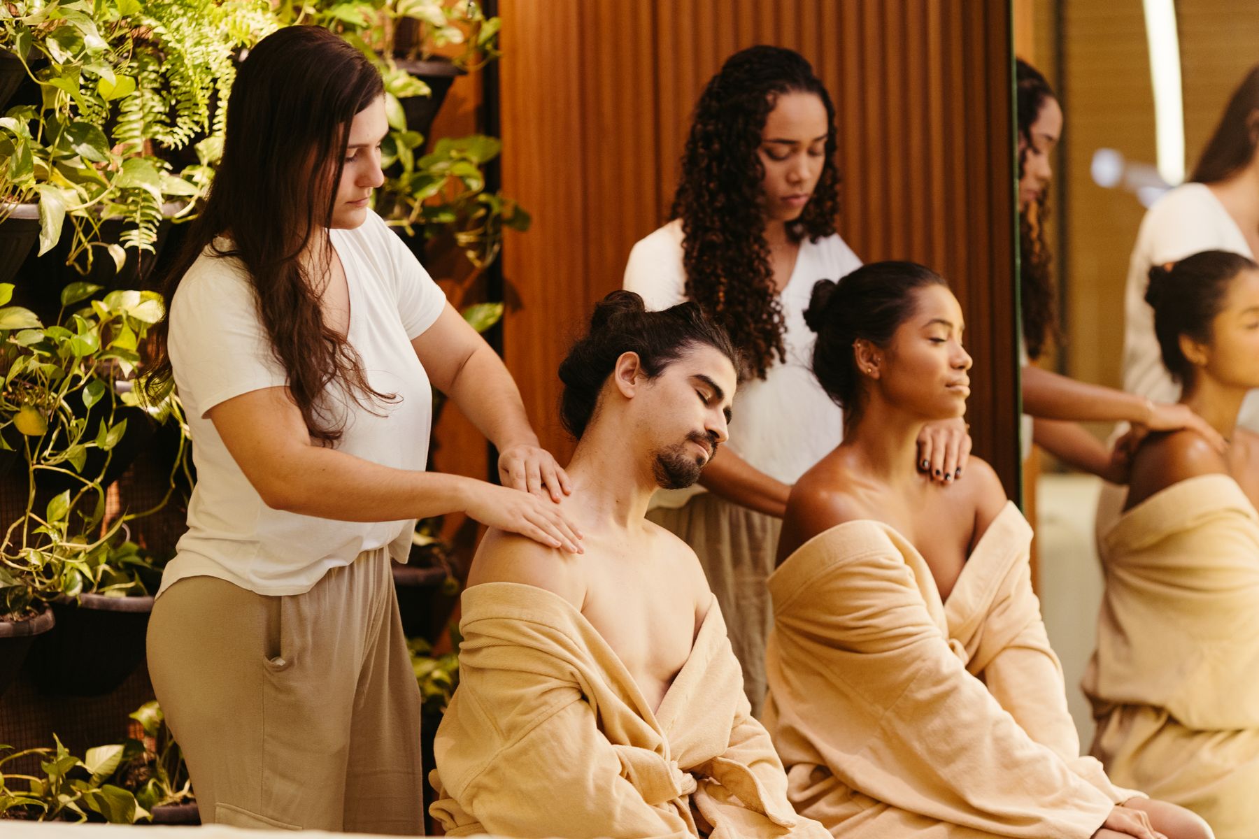 Two clients receiving treatments from professional massage therapists