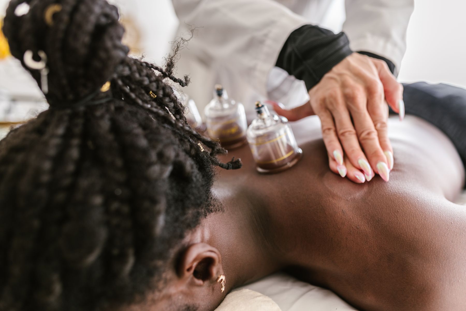 Professional therapist applying cups during a cupping treatment