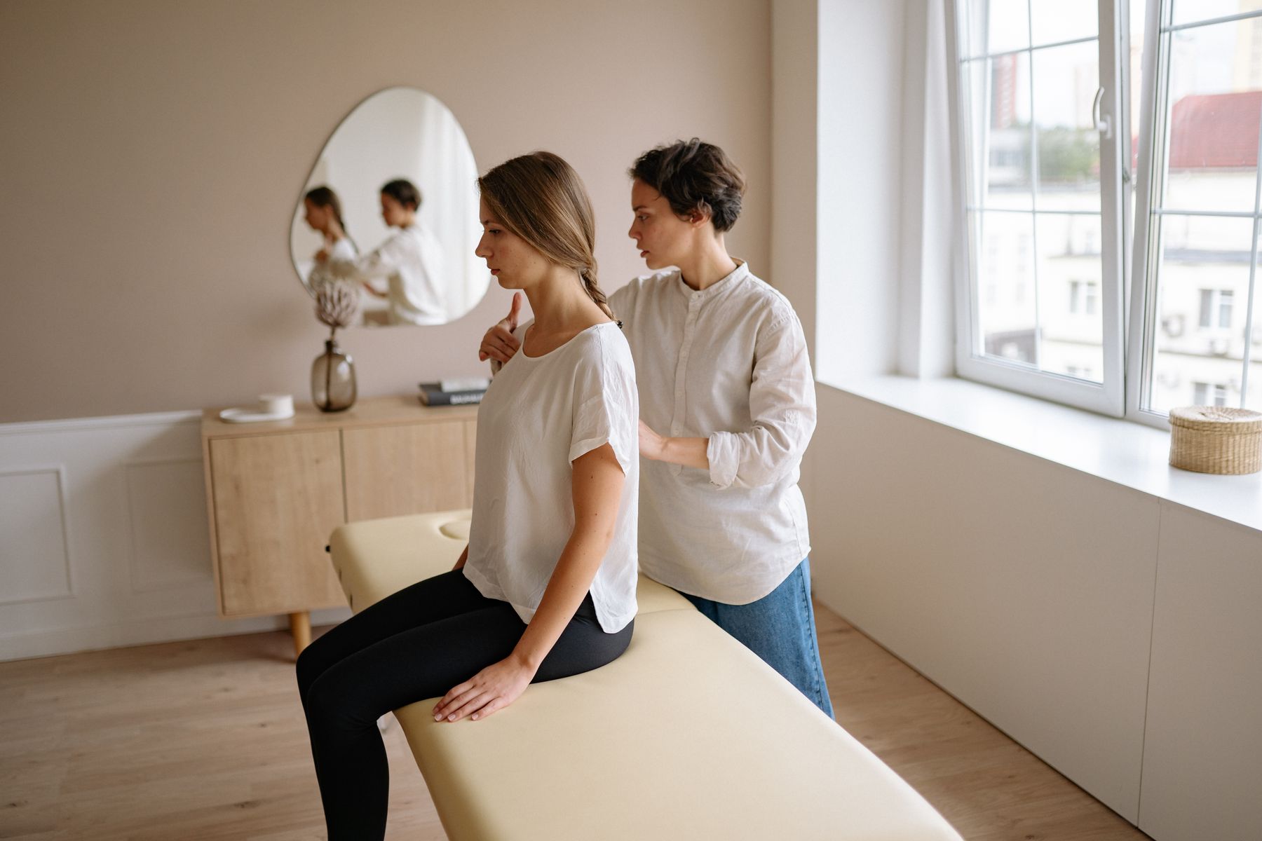 Massage therapist providing a relaxing shoulder treatment in a peaceful spa