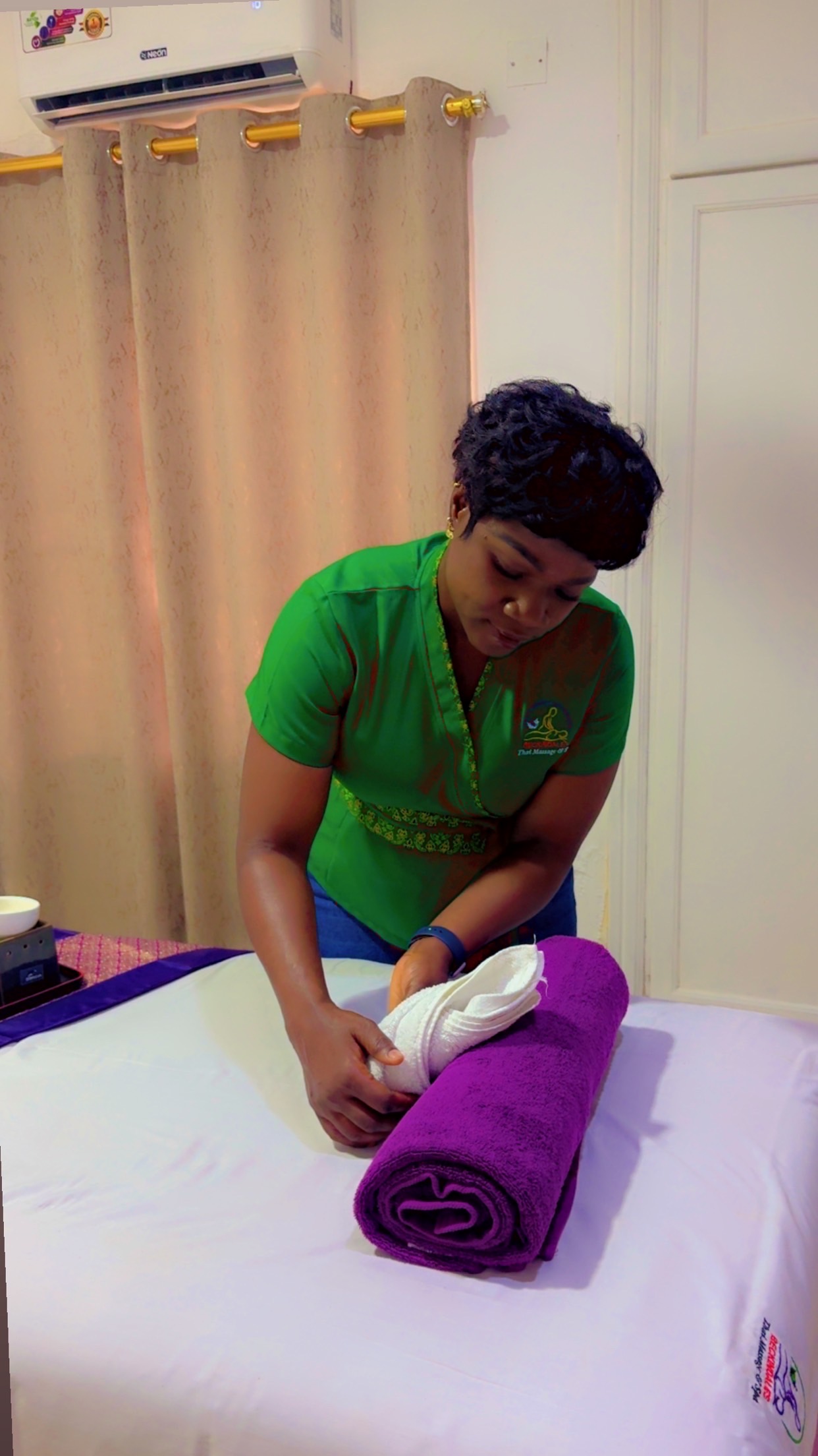 Becky, Founder and Lead Ghanaian Therapist at Beckindales, preparing a massage treatment room